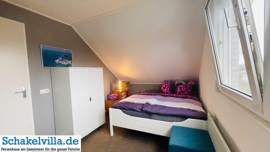 Schlafmöglichkeiten in der Schakelvilla 3 Queensizebett 160x200 cm mit elektrisch verstellbaren Lattenrosten im Schlafzimmer zum Parkplatz - Schakelvilla Ferienhaus in Makkum am IJsselmeer